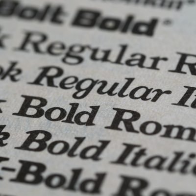 Detailed view of different font styles printed on paper, showcasing typography.
