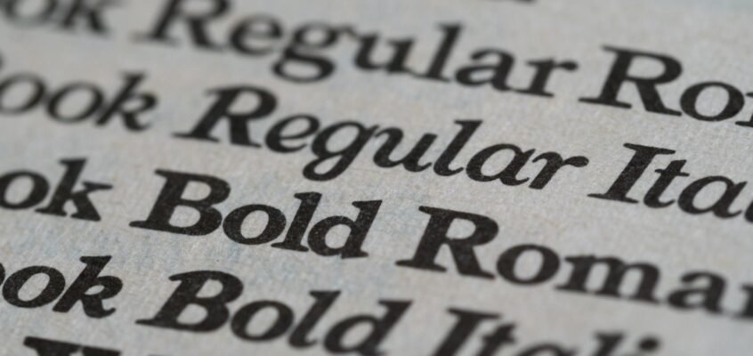 Detailed view of different font styles printed on paper, showcasing typography.